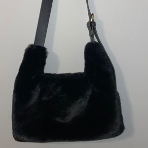 Black fur bag with gold hardware. Roomy on the inside